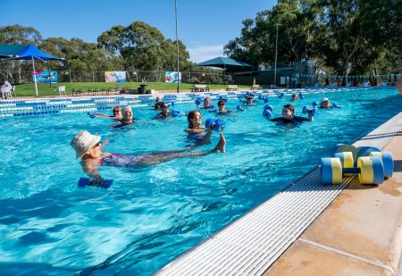 Women in pool doing aquarobics